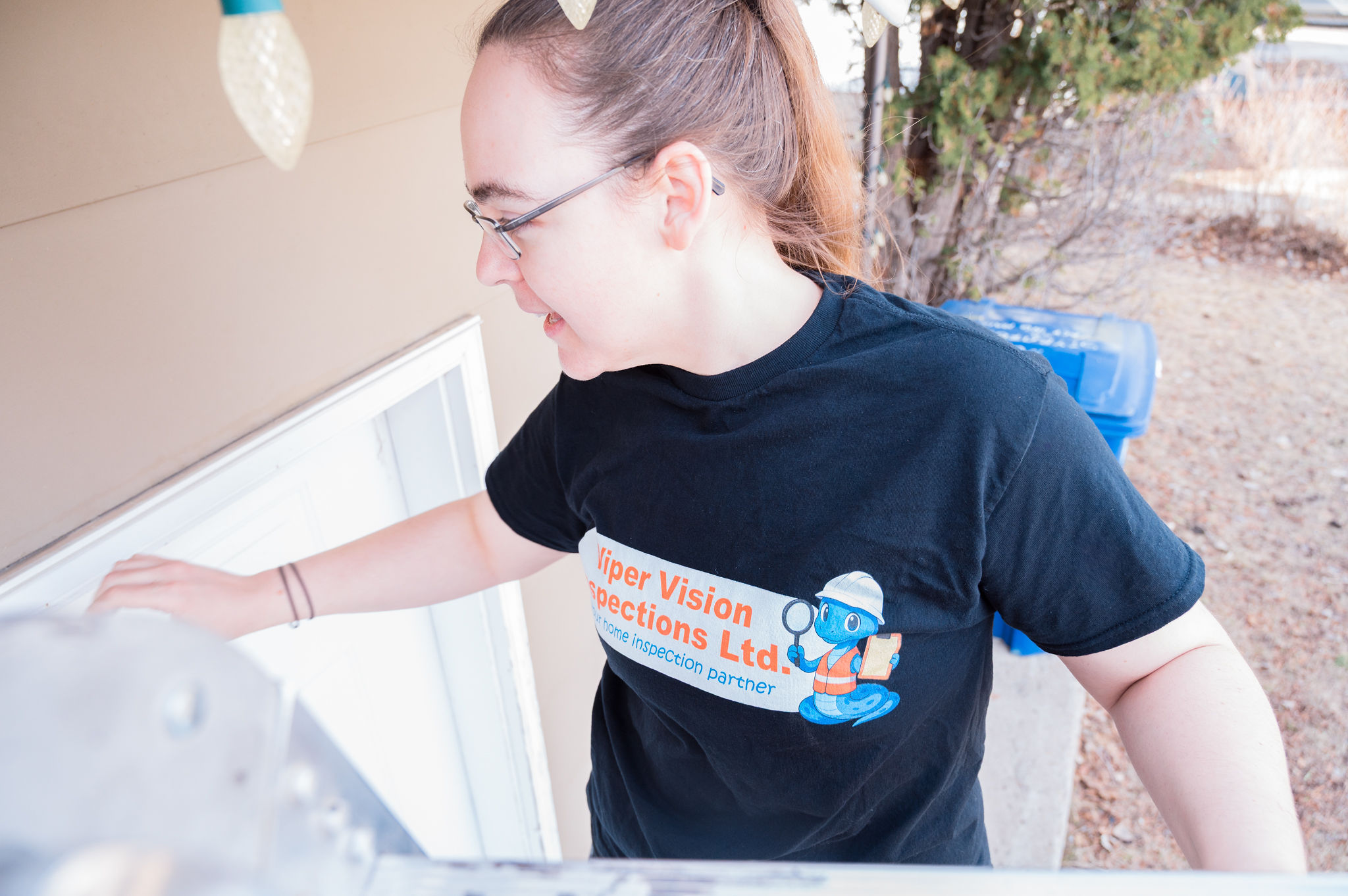 Inspector checking flashing at the top of an exterior door