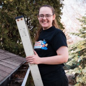 Home inspector Tara on a ladder